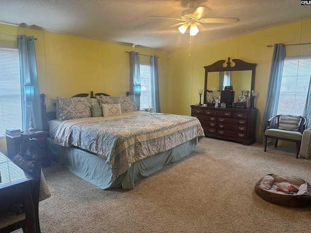 carpeted bedroom with ceiling fan and a textured ceiling