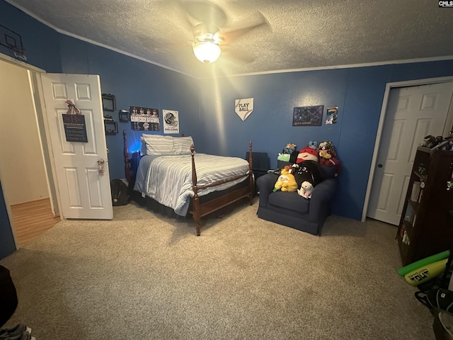 bedroom featuring crown molding, ceiling fan, carpet flooring, and a textured ceiling