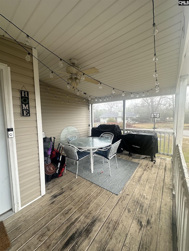 wooden deck featuring a grill and ceiling fan