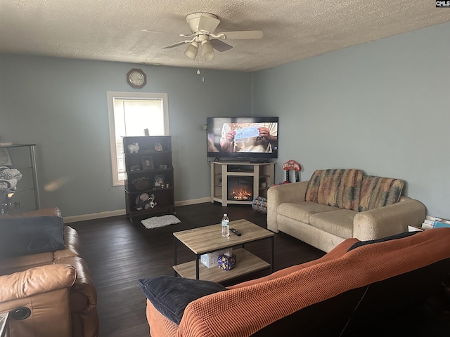 living room with ceiling fan, a textured ceiling, and dark hardwood / wood-style flooring