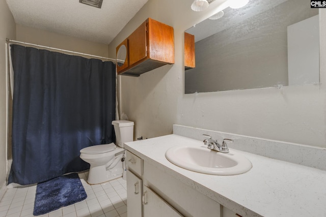 full bathroom featuring vanity, tile patterned floors, a textured ceiling, and toilet