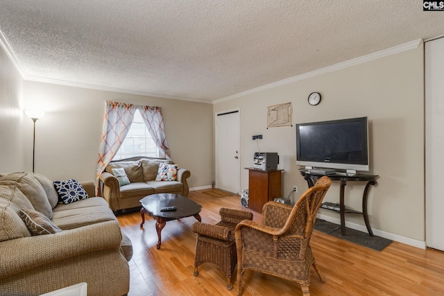 living room featuring ornamental molding, a textured ceiling, and light wood-type flooring