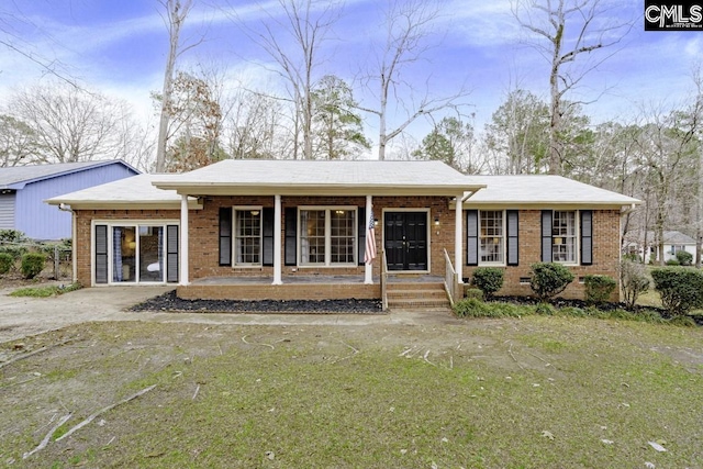 ranch-style house with a porch and a front lawn