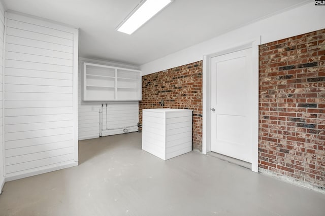 interior space featuring brick wall