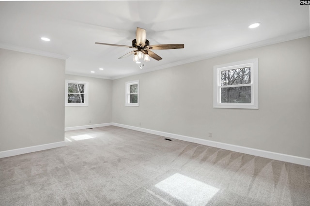 carpeted spare room featuring ceiling fan and ornamental molding