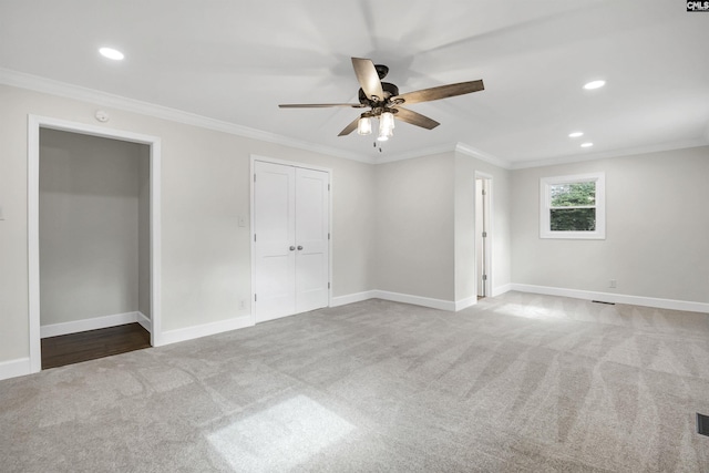 unfurnished bedroom featuring crown molding, ceiling fan, and carpet