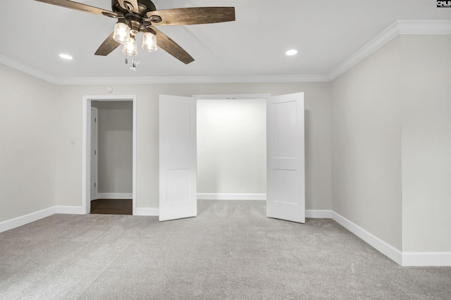 unfurnished bedroom with crown molding, carpet flooring, and ceiling fan