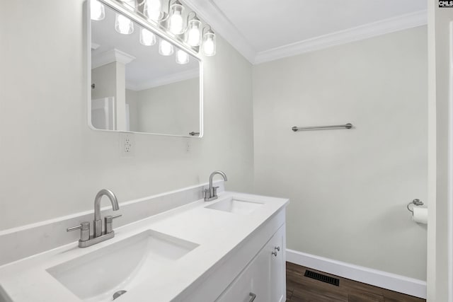 bathroom featuring hardwood / wood-style flooring, ornamental molding, and vanity