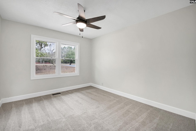 spare room featuring carpet floors and ceiling fan