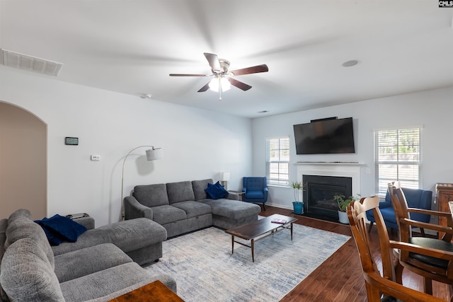 576 Flat Creek Dr, Blythewood, SC 29016 - living room with wood finished floors, visible vents, a fireplace with flush hearth, arched walkways, and ceiling fan