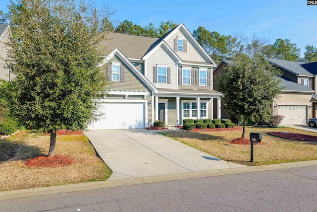 view of front of property with concrete driveway, an attached garage, board and batten siding, and a front yard