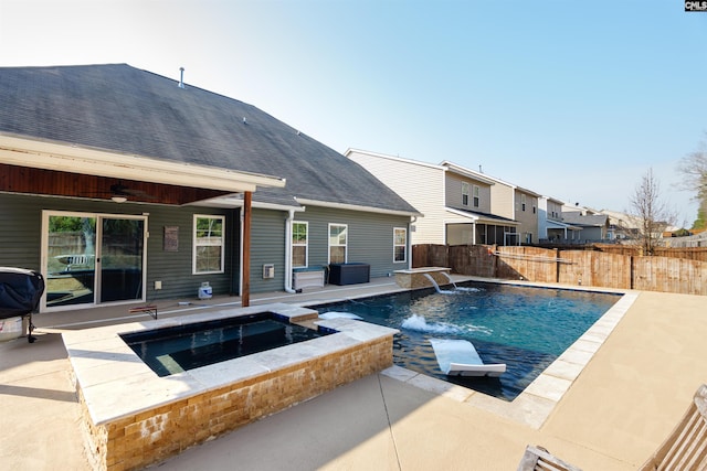 view of pool with an in ground hot tub, ceiling fan, a patio, and pool water feature