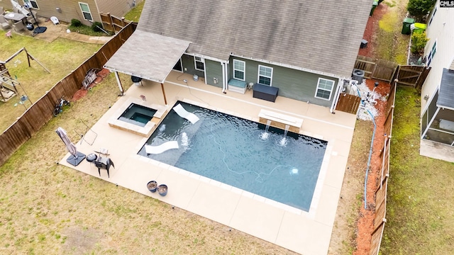 576 Flat Creek Dr, Blythewood, SC 29016 - view of swimming pool featuring a fenced backyard, a diving board, a pool with connected hot tub, a patio area, and a lawn
