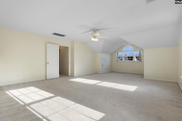 additional living space featuring light carpet, lofted ceiling, and ceiling fan