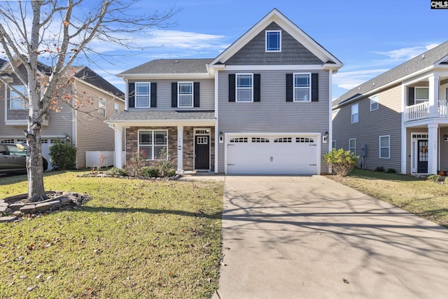 view of front of home featuring a garage, a front yard, and covered porch