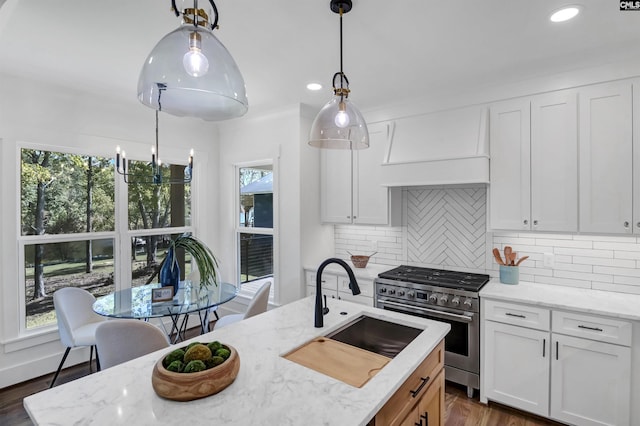 387 Bedford Way, Prosperity, SC 29127 - kitchen with white cabinetry, premium range hood, pendant lighting, and stainless steel stove