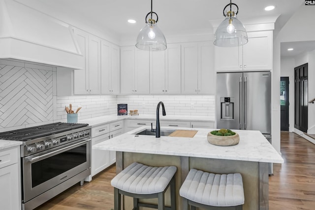 387 Bedford Way, Prosperity, SC 29127 - kitchen with pendant lighting, a kitchen island with sink, white cabinetry, high quality appliances, and light stone countertops
