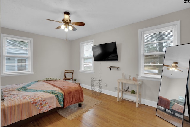 bedroom with ceiling fan and light hardwood / wood-style floors