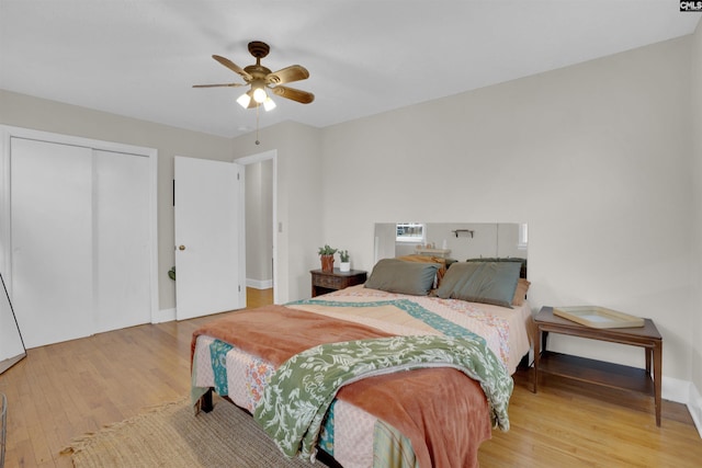 bedroom with a closet, ceiling fan, and light hardwood / wood-style flooring