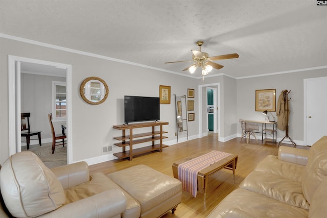 living room featuring crown molding, a textured ceiling, and hardwood / wood-style flooring