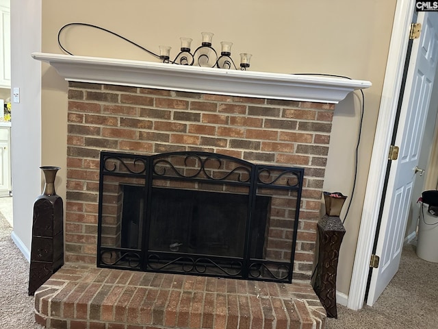 details featuring a fireplace and carpet