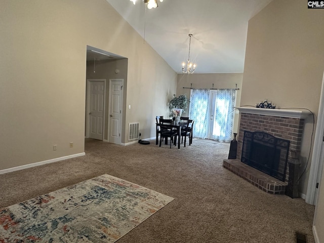 carpeted dining room featuring a notable chandelier, a fireplace, and high vaulted ceiling