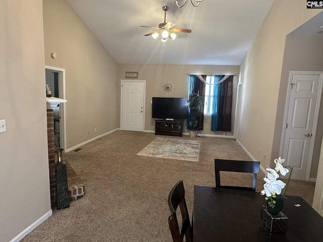 living room with a fireplace, carpet floors, ceiling fan, and vaulted ceiling