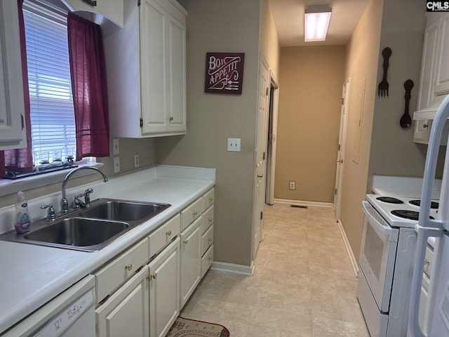 kitchen with white cabinetry, sink, and white appliances