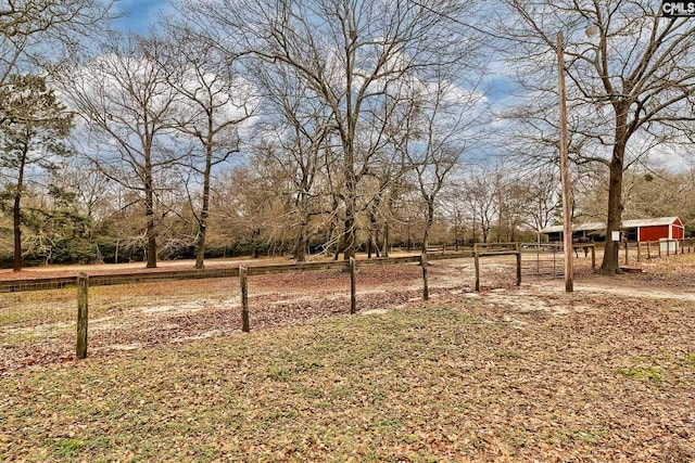 view of yard featuring a rural view and an outdoor structure