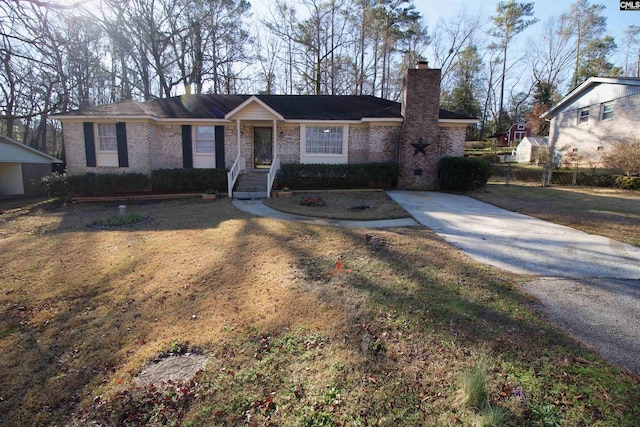 ranch-style home featuring brick siding, a chimney, a front yard, crawl space, and fence