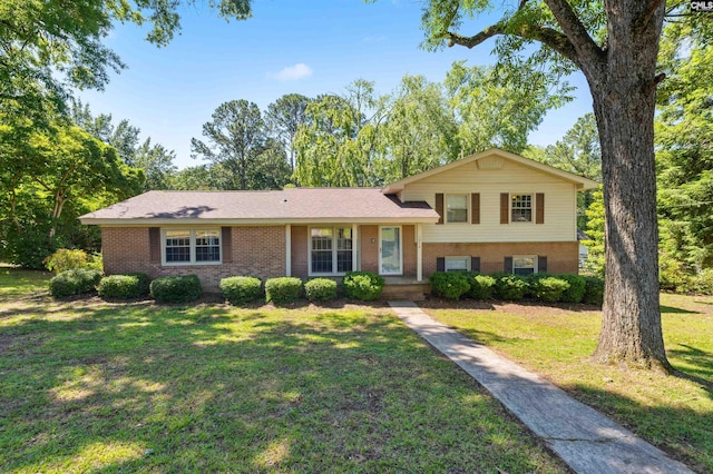 split level home with a front lawn