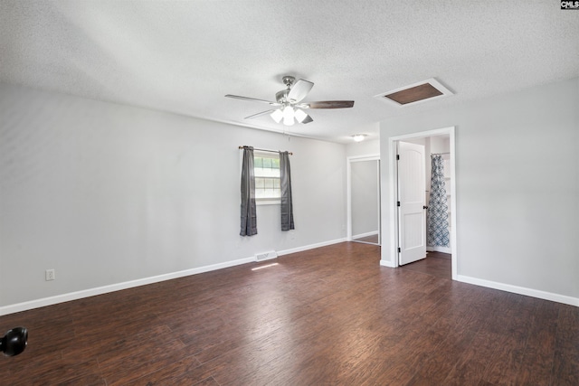 interior space with ceiling fan, dark wood-type flooring, and a textured ceiling