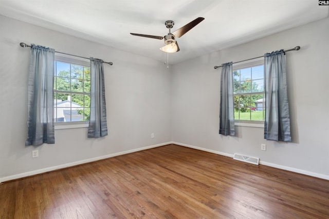 empty room featuring hardwood / wood-style floors and ceiling fan