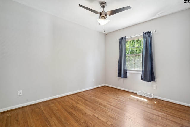 spare room with hardwood / wood-style floors and ceiling fan