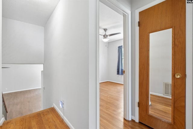 hallway with hardwood / wood-style flooring