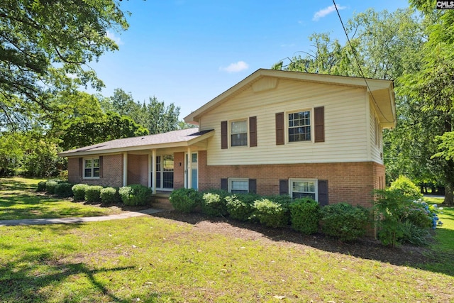 split level home with a porch and a front lawn