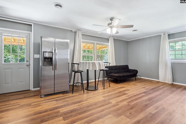 sitting room with light hardwood / wood-style flooring, ornamental molding, and ceiling fan