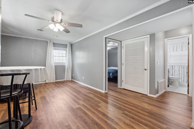 interior space with hardwood / wood-style flooring, ceiling fan, and ornamental molding