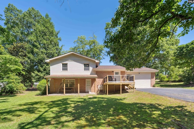 view of front of home featuring a front lawn and a deck