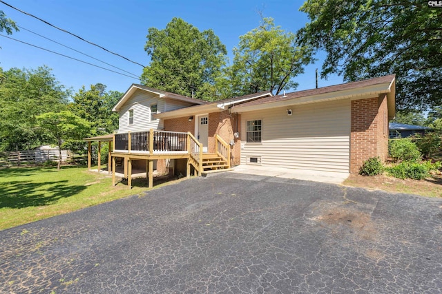 view of front of home featuring a deck and a front lawn