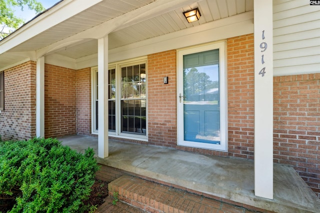 view of exterior entry with covered porch