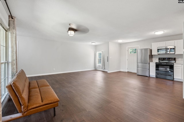 unfurnished living room with dark hardwood / wood-style floors