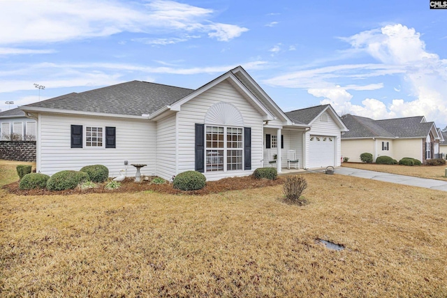 ranch-style house with a garage and a front lawn