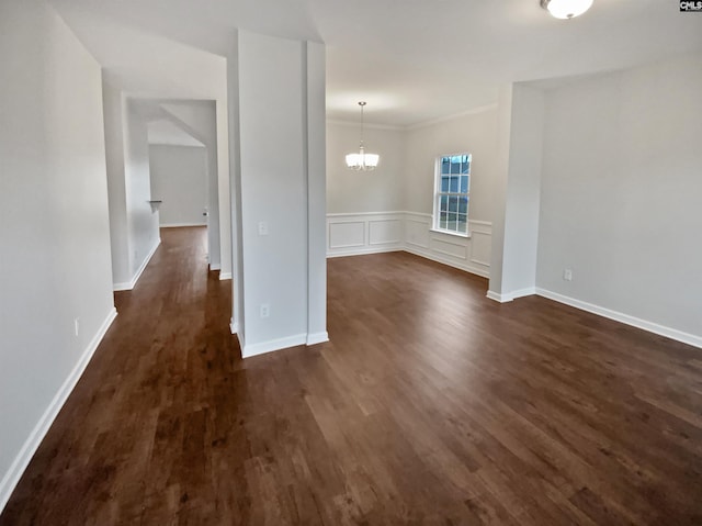 interior space featuring crown molding, dark hardwood / wood-style floors, and an inviting chandelier