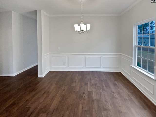 unfurnished dining area with dark hardwood / wood-style flooring, crown molding, and a chandelier