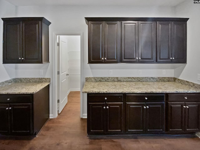 kitchen with dark wood-type flooring and dark brown cabinetry