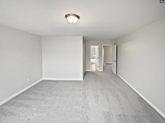 unfurnished room featuring light colored carpet