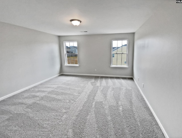 spare room with plenty of natural light and carpet