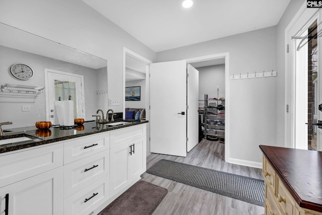 kitchen featuring sink, wooden counters, white cabinets, and light wood-type flooring