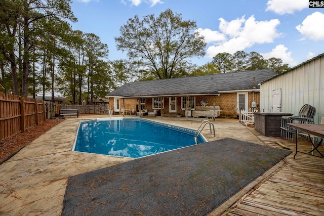 view of swimming pool featuring exterior bar and a patio area